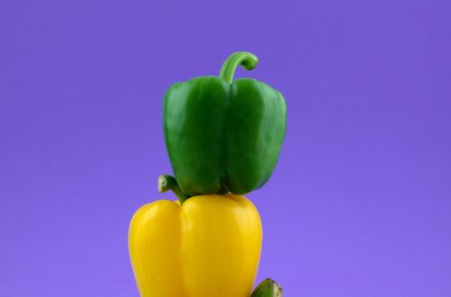a couple of peppers sitting on top of each other