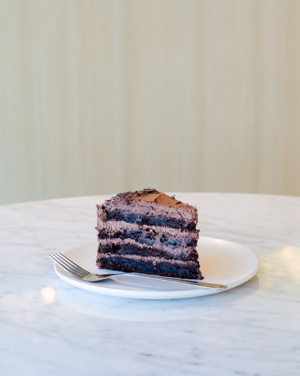 sliced chocolate cake beside fork on plate